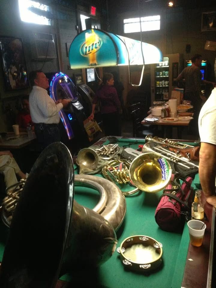Brass instruments resting on the pool table inside Marie's Bar.